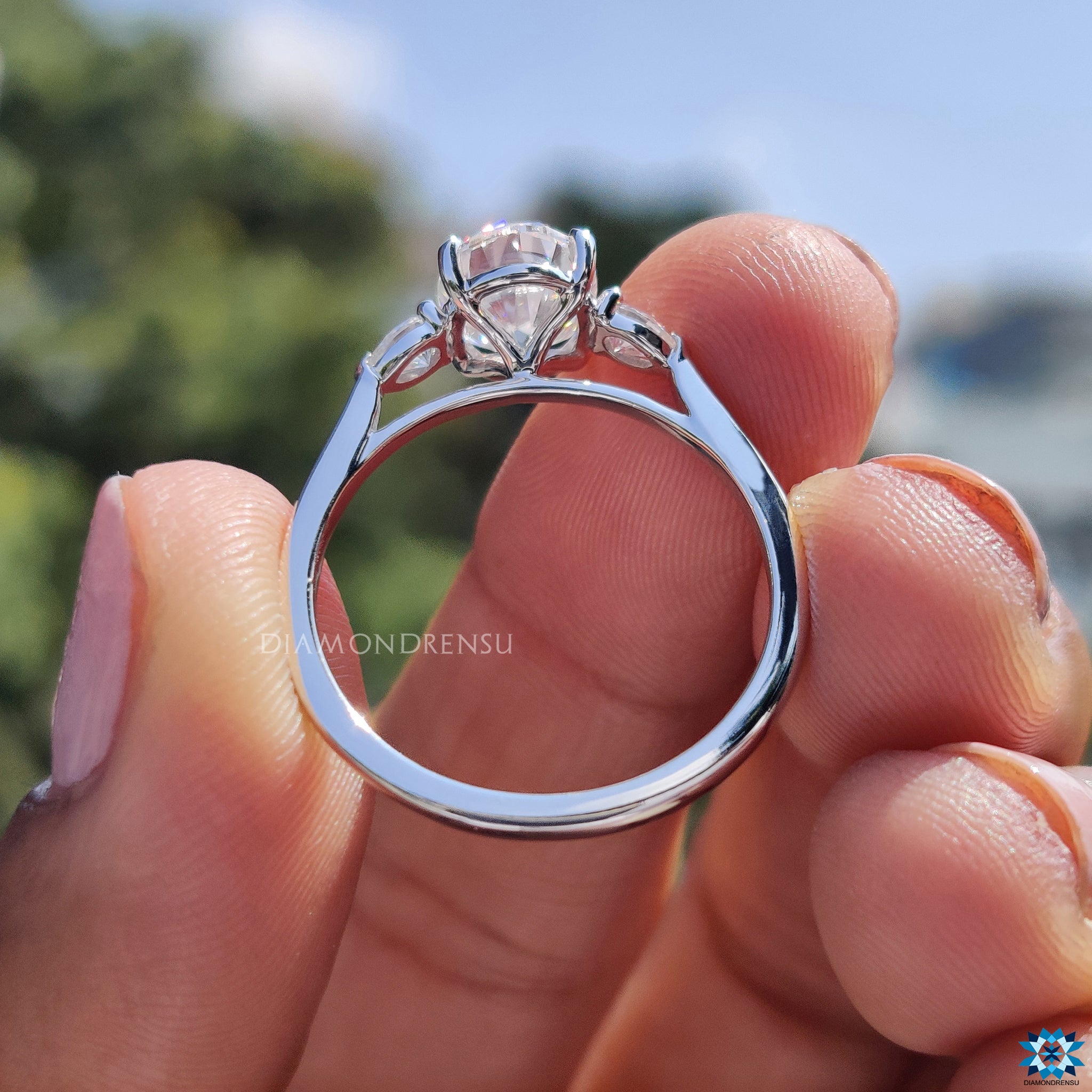 UK engagement ring featuring oval and pear cut moissanite design.
