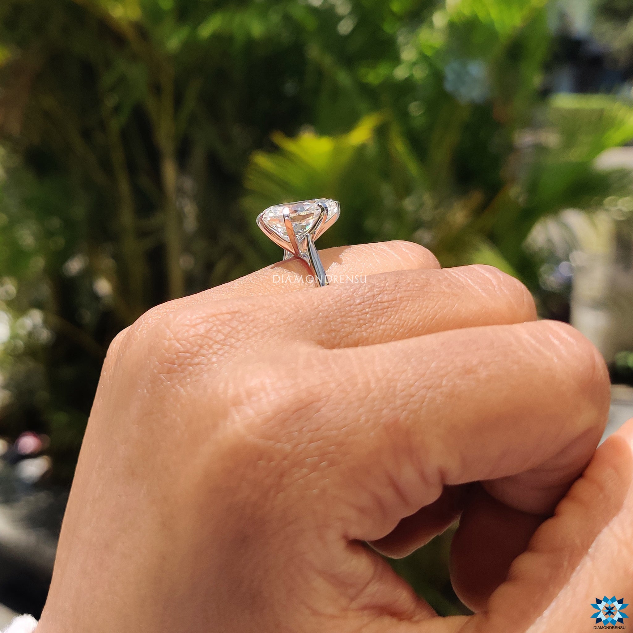 Elegant engagement ring with pear Rensu cut moissanite in a handmade cathedral setting.

