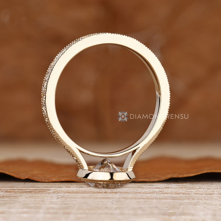 Bezel set oval diamond ring with art deco style.