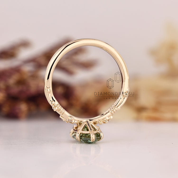 Diamondrensu UK green diamond ring with leaf style prongs.