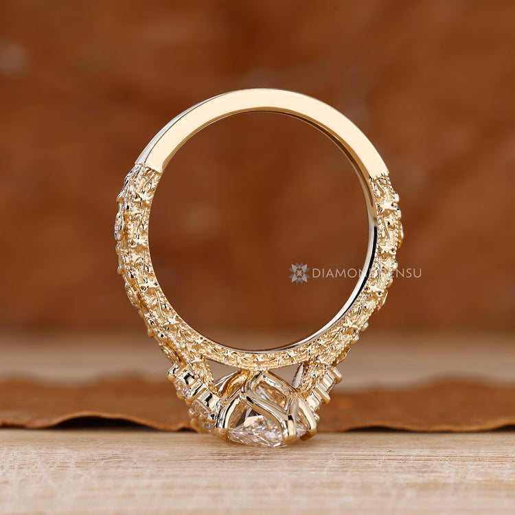 Round side stone marquise ring with tulip setting.