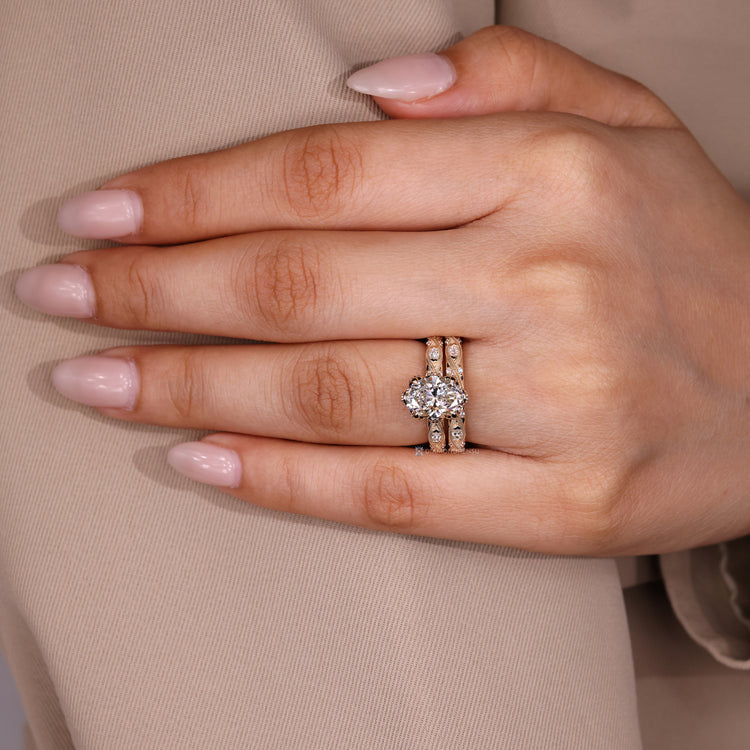 Handmade oval diamond ring with marquise side stones.