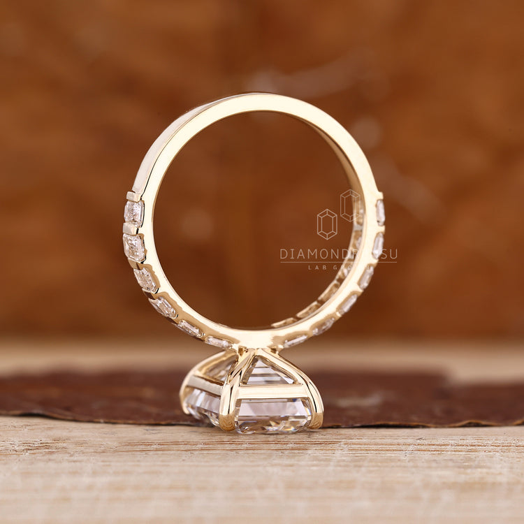 Emerald cut engagement ring with secure four prongs.