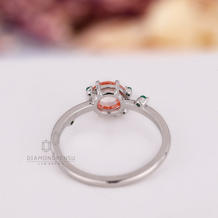 Round rose cut sapphire ring with emerald cluster sides.