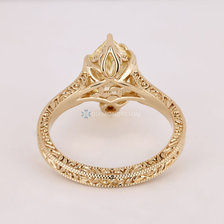 Handmade yellow diamond ring with milgrain details.