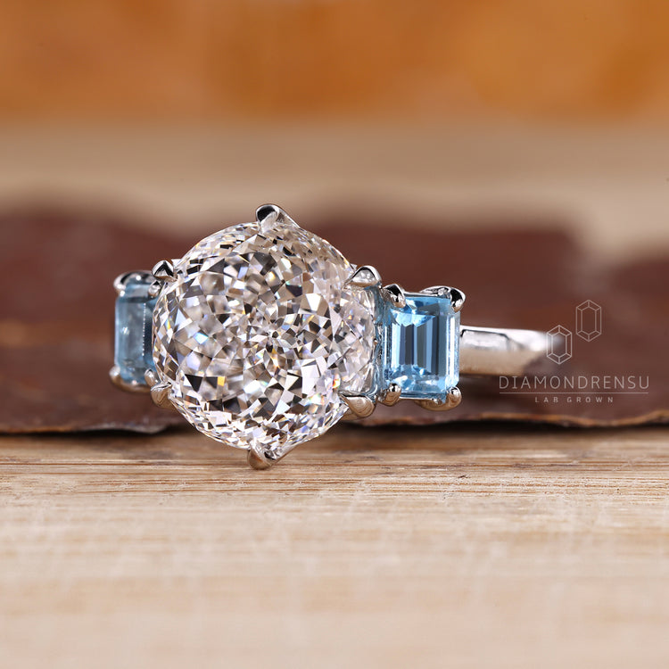Handmade three stone diamond ring with blue sapphire accents.