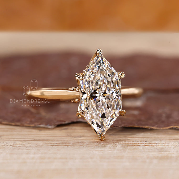 Marquise diamond ring with round hidden halo and bridge detail.