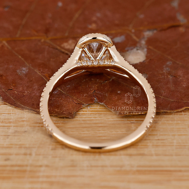 Oval halo engagement ring with pave split shank design.