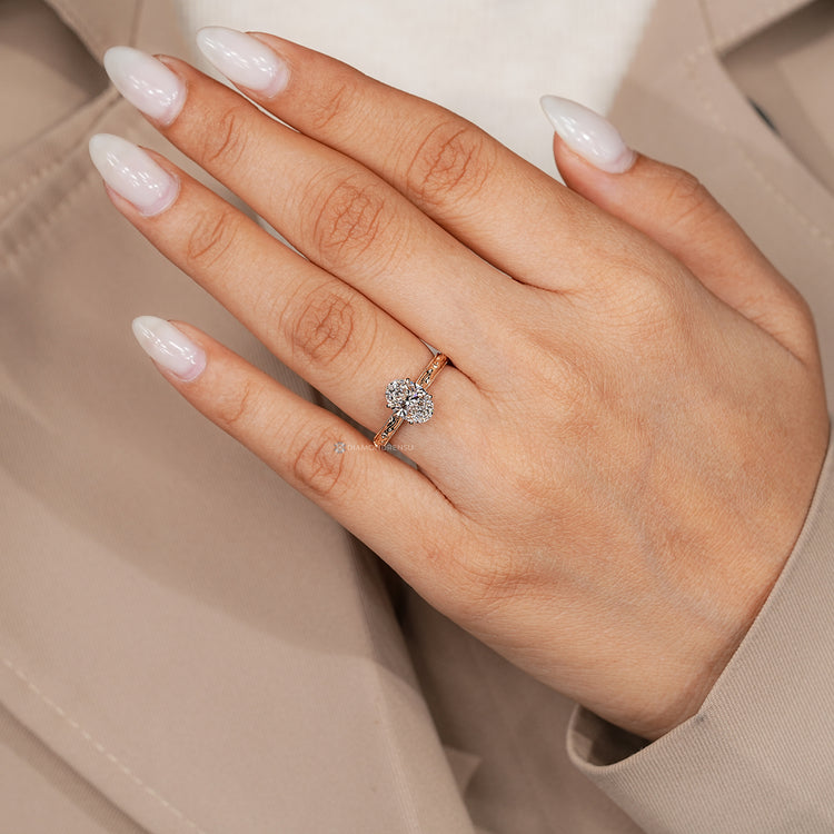 Oval diamond ring with hidden round diamonds.