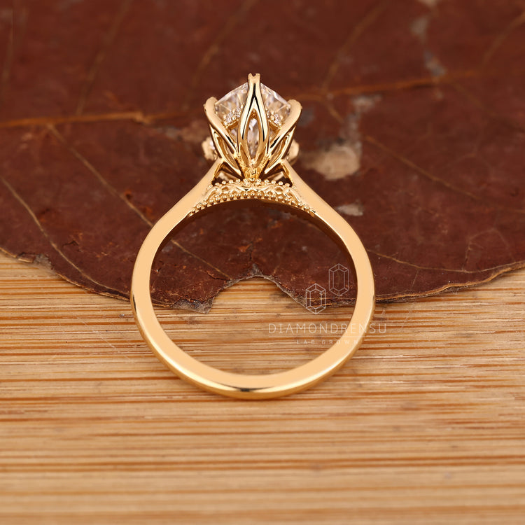Marquise diamond ring with hidden halo and bridge accent.