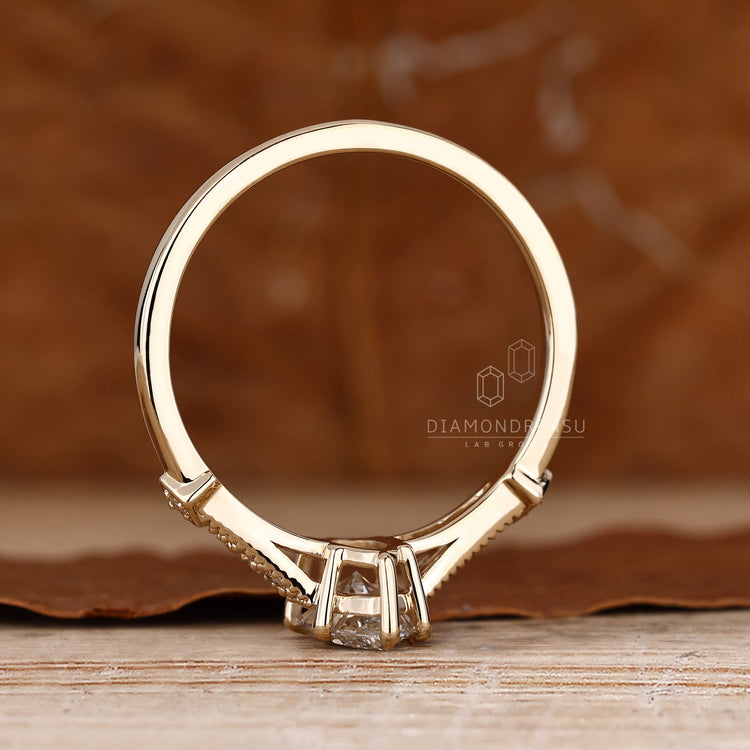 Marquise diamond ring with cathedral setting and side stones.