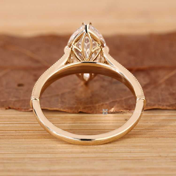 Marquise diamond ring with tulip and cathedral setting.