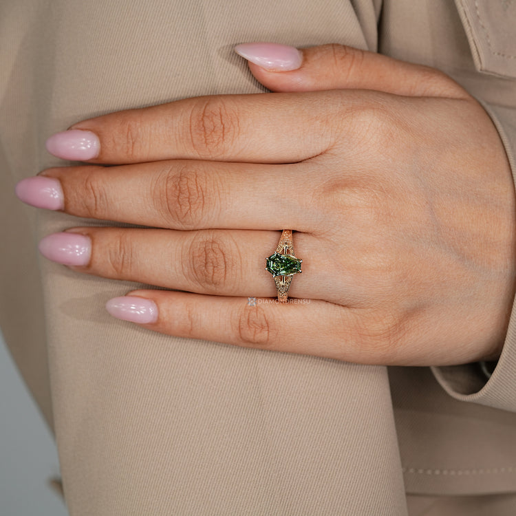Green centre diamond ring with cathedral setting.