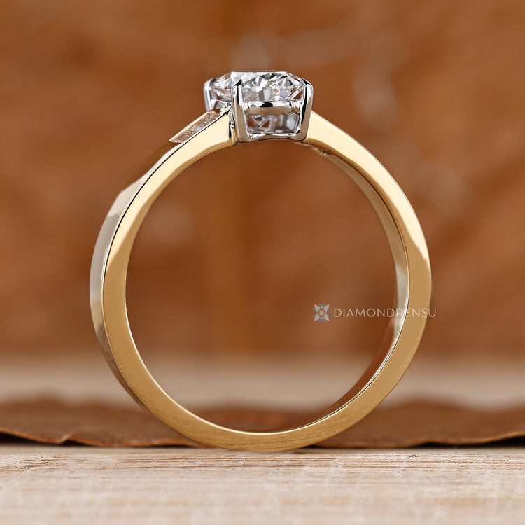 Oval lab grown diamond ring with four claw prongs.