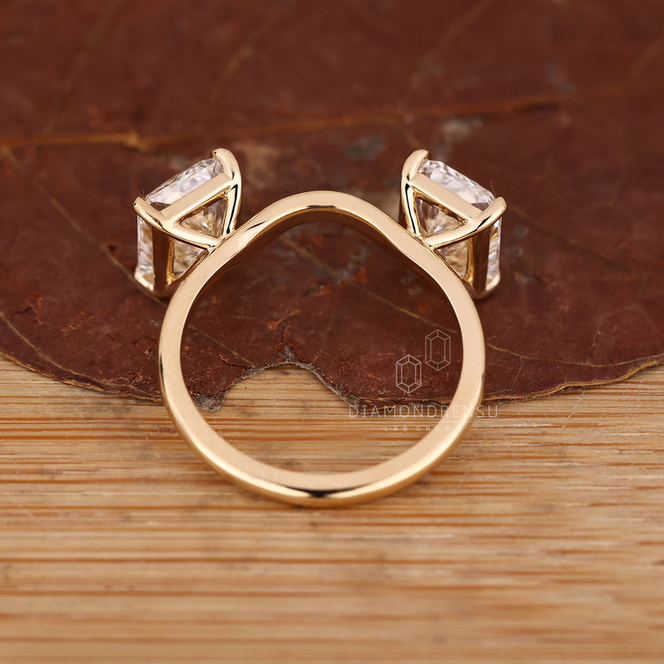 Two stone radiant diamond ring with stackable curved design.