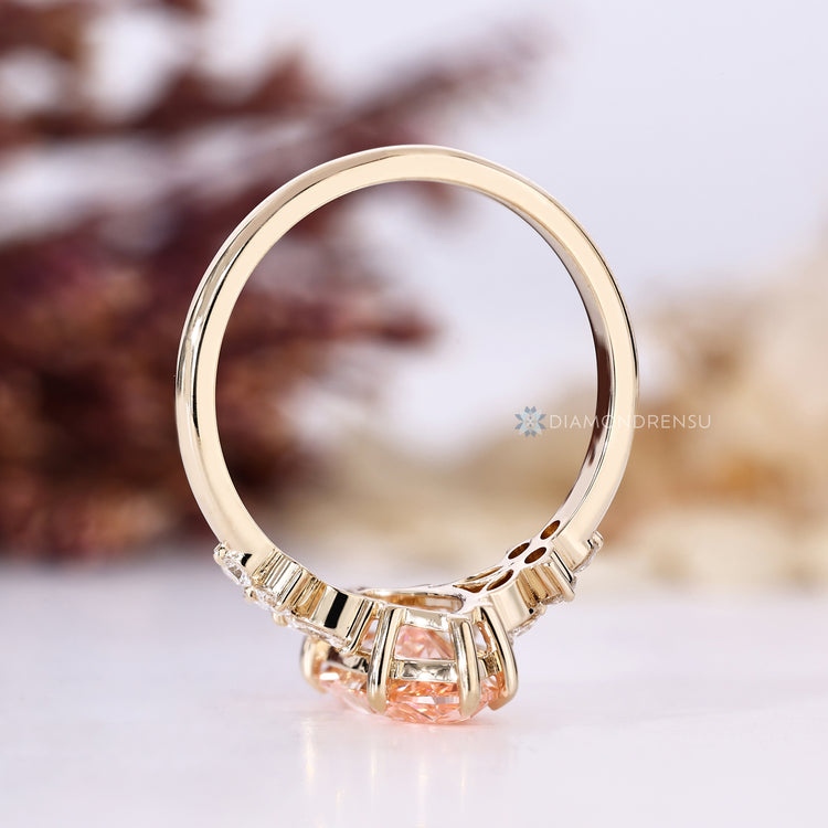 Pink centre diamond ring with marquise side stones.