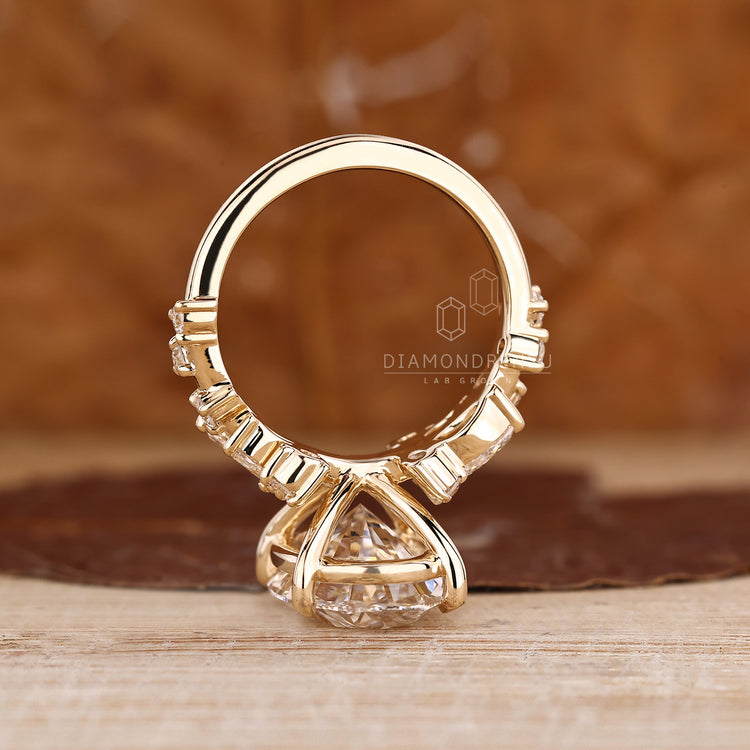 Oval diamond ring with marquise and round cluster accents.