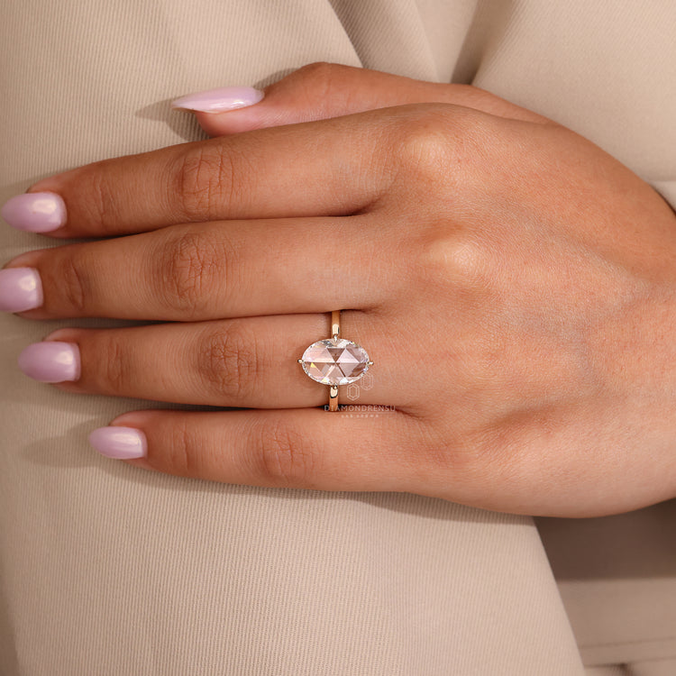 Lab grown oval diamond ring with compass prong setting.