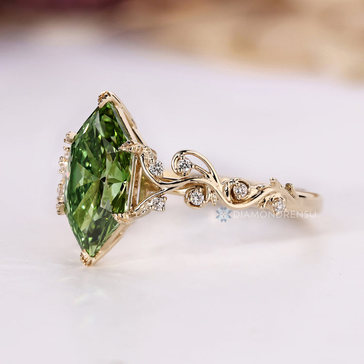 Handmade green centre diamond ring with round side stones.