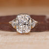 Cushion cut diamond ring with trillion side stones.