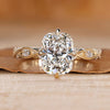 Cushion cut diamond ring with round side stones.