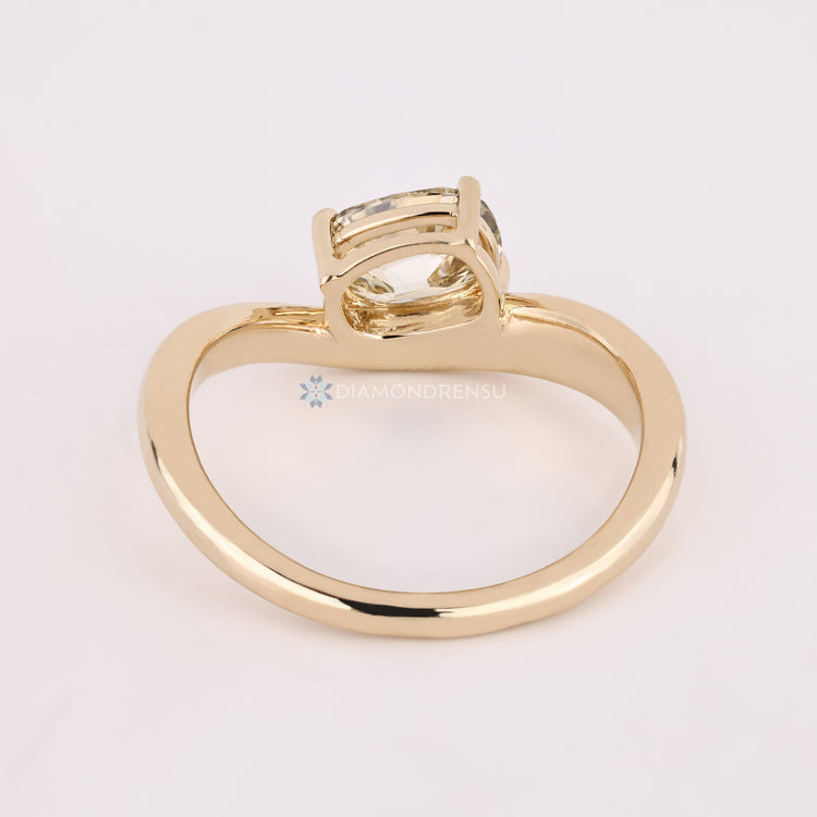 Handmade yellow cushion diamond ring with prong setting.