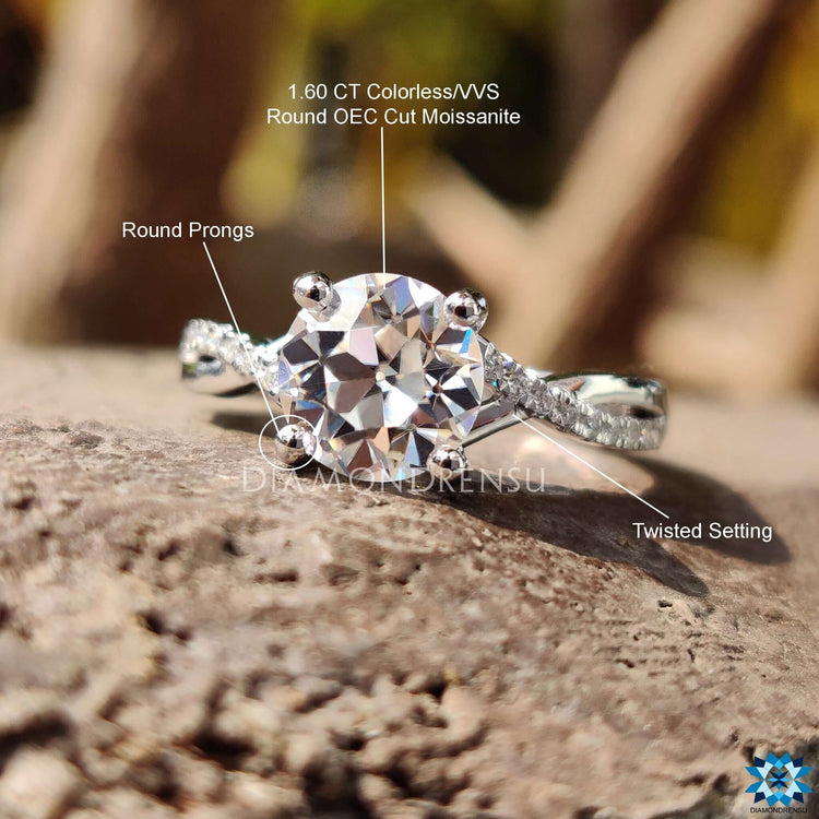Twisted band ring with round moissanite and pave setting.
