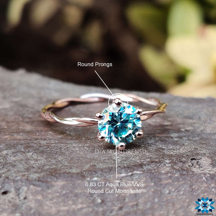 Moissanite ring with a unique twisted band design.
