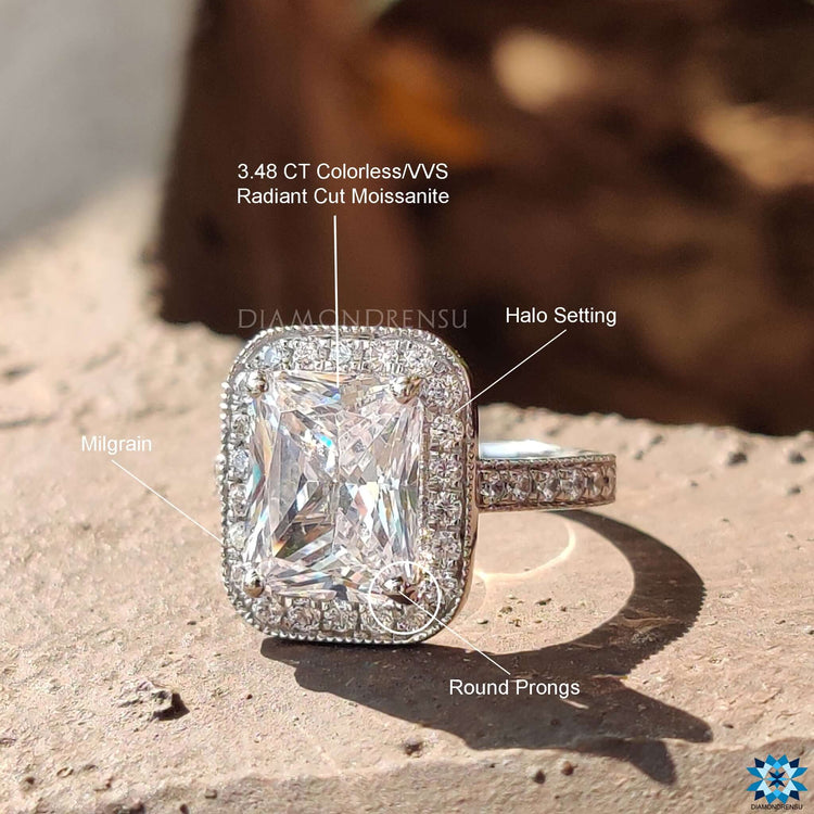 Radiant moissanite ring with milgrain border.
