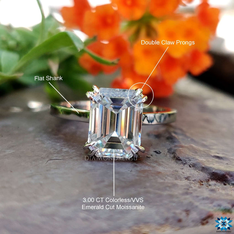 Classic white gold engagement ring with emerald moissanite.
