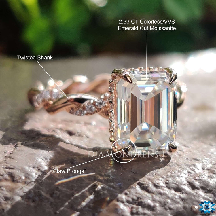 Custom engagement ring with round accents and emerald center.
