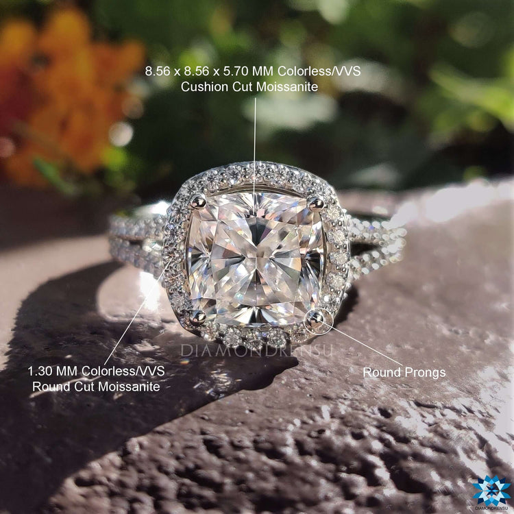 Prong set cushion cut ring with round moissanite accents.
