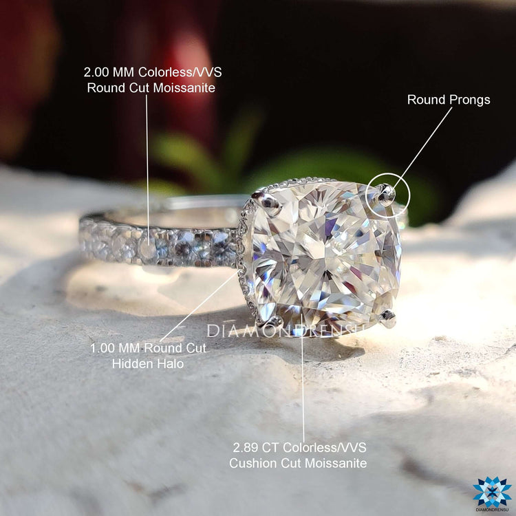 Elegant cushion moissanite ring with halo accents.

