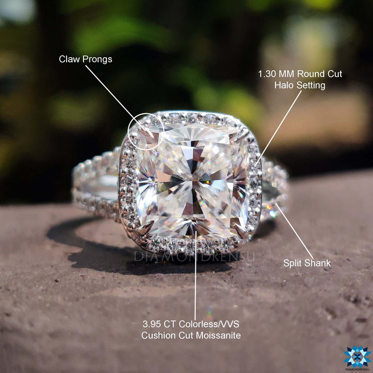 White gold engagement ring with cushion cut and halo detail.
