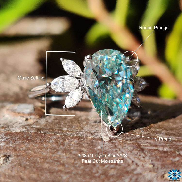 Engagement ring with pear moissanite and marquise accents.
