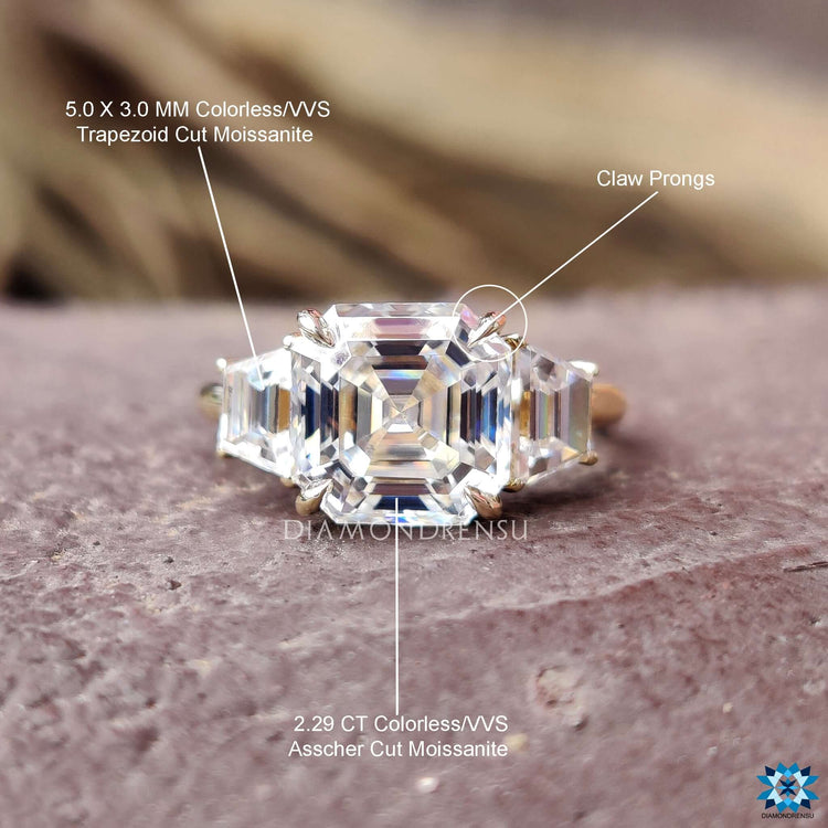 Modern three stone ring with structured Asscher and trapezoid layout.
