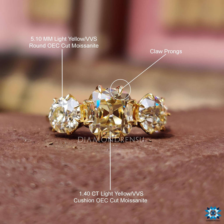 Old mine cut cushion ring with round old European accents.
