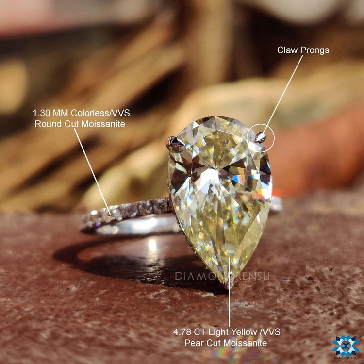 Custom white gold ring featuring round brilliant cut side stones.

