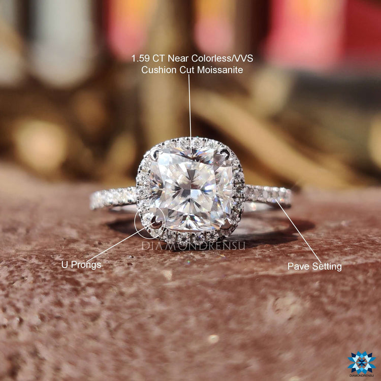 Pave set engagement ring with cushion center in white gold.
