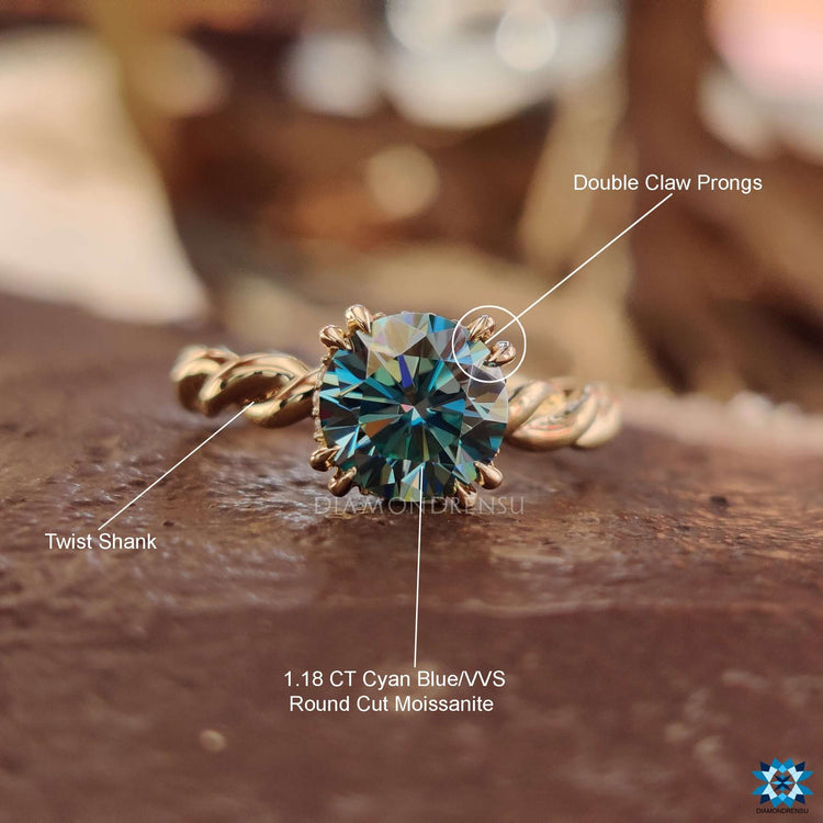 Yellow gold ring with hidden halo and round cut blue moissanite.
