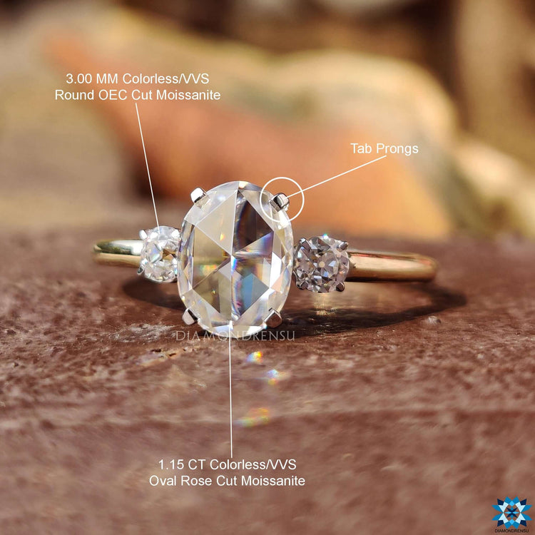 Elegant three stone setting with old European cuts in white and yellow gold.
