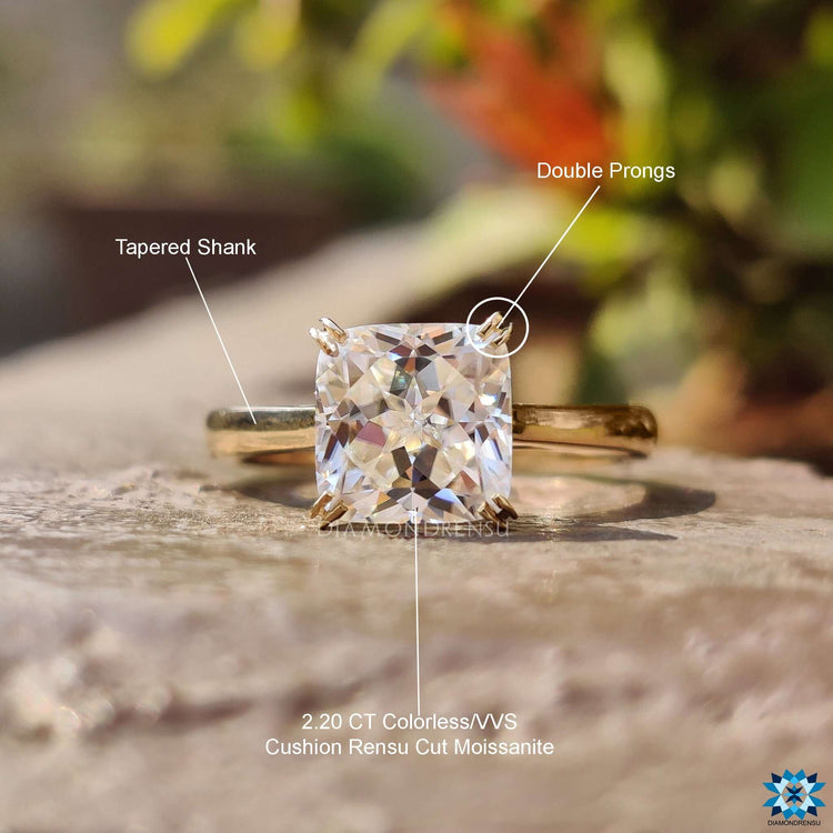 Yellow gold solitaire ring with cushion cut stone.
