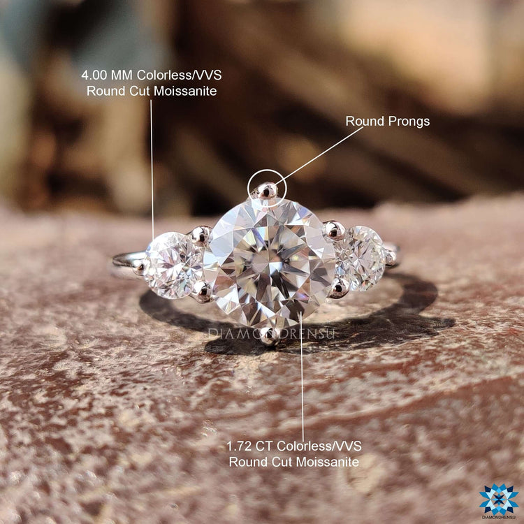 Trio round moissanite engagement ring in handcrafted gold.
