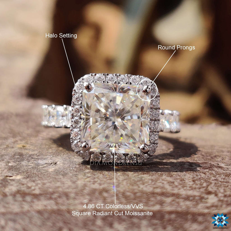 Radiant engagement ring featuring round pave halo and square center stone.
