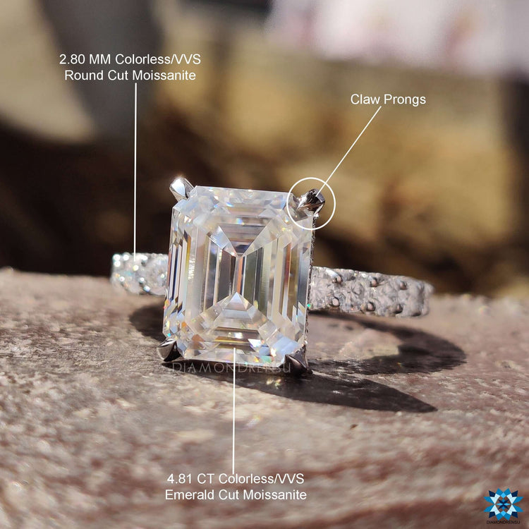 Custom engagement ring featuring emerald cut center stone.
