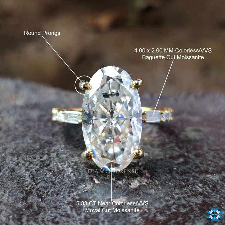 Round and baguette moissanite moval cut ring in yellow gold.
