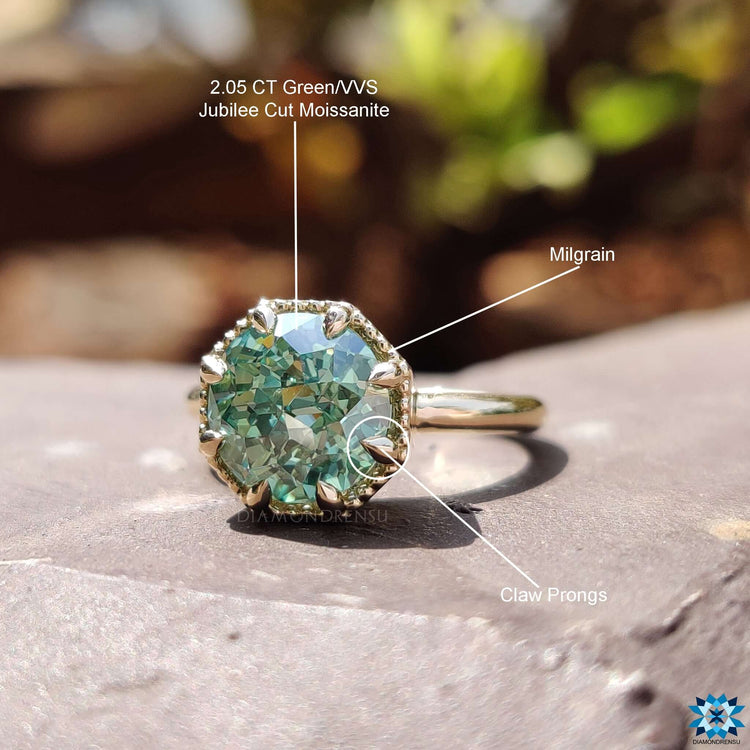 Solitaire engagement ring with green moissanite stone.
