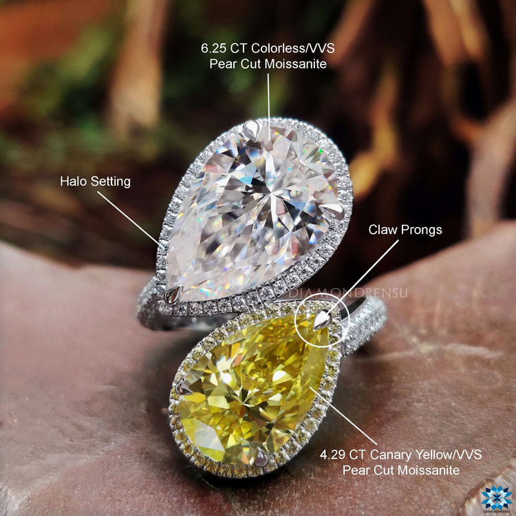 White gold 2 stone ring featuring asymmetric pear moissanite layout.
