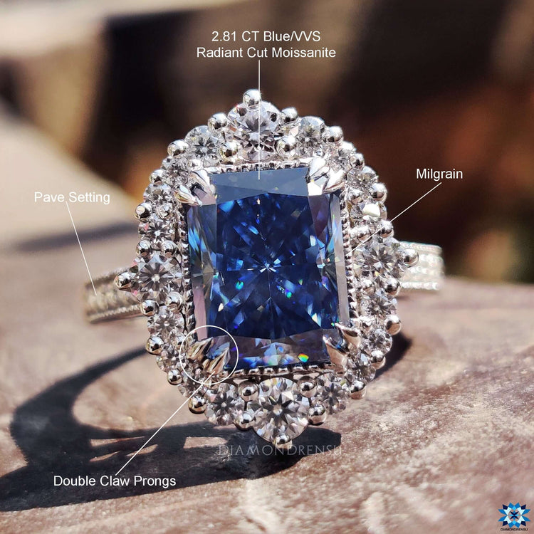 Elegant cathedral setting ring with radiant cut blue moissanite.
