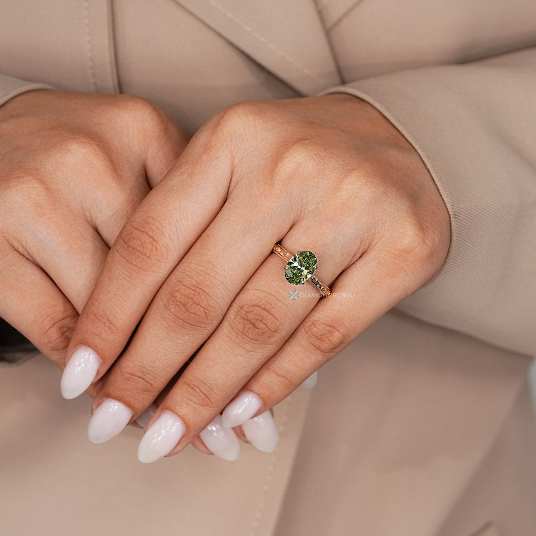 Oval engagement ring with hidden flower and leaf design.